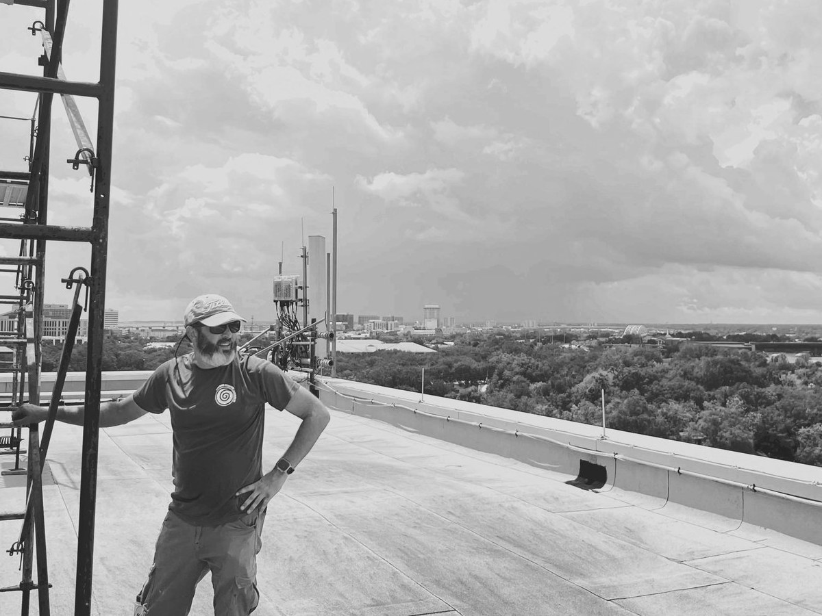 Nick Bruno, owner of Grand Strand Visuals, on a commercial rooftop sign installation