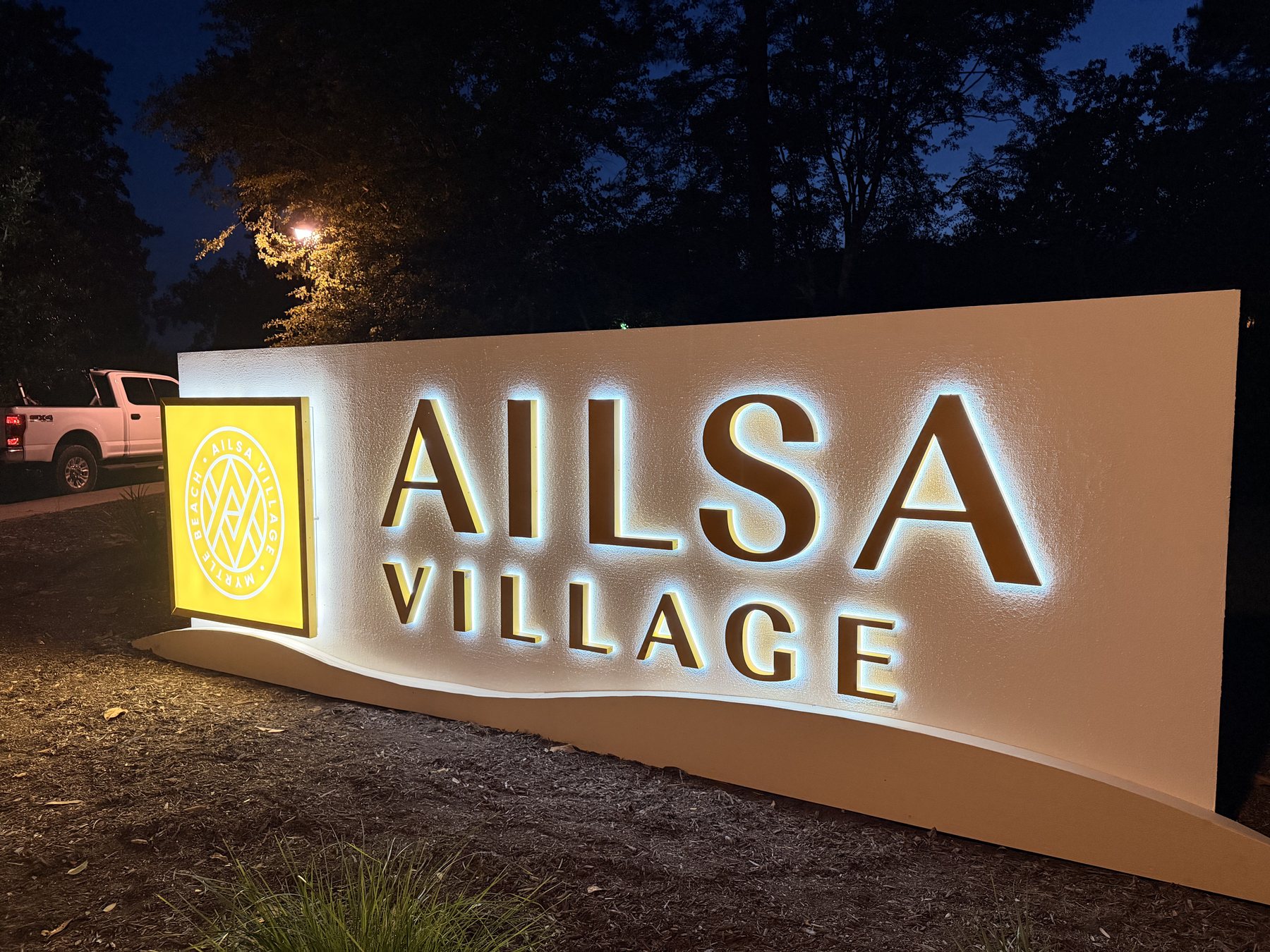 Angled view of Ailsa Village illuminated monument sign