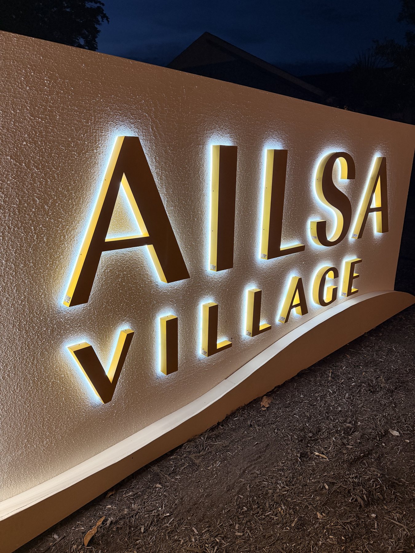 Close-up of halo-lit Ailsa Village monument sign letters