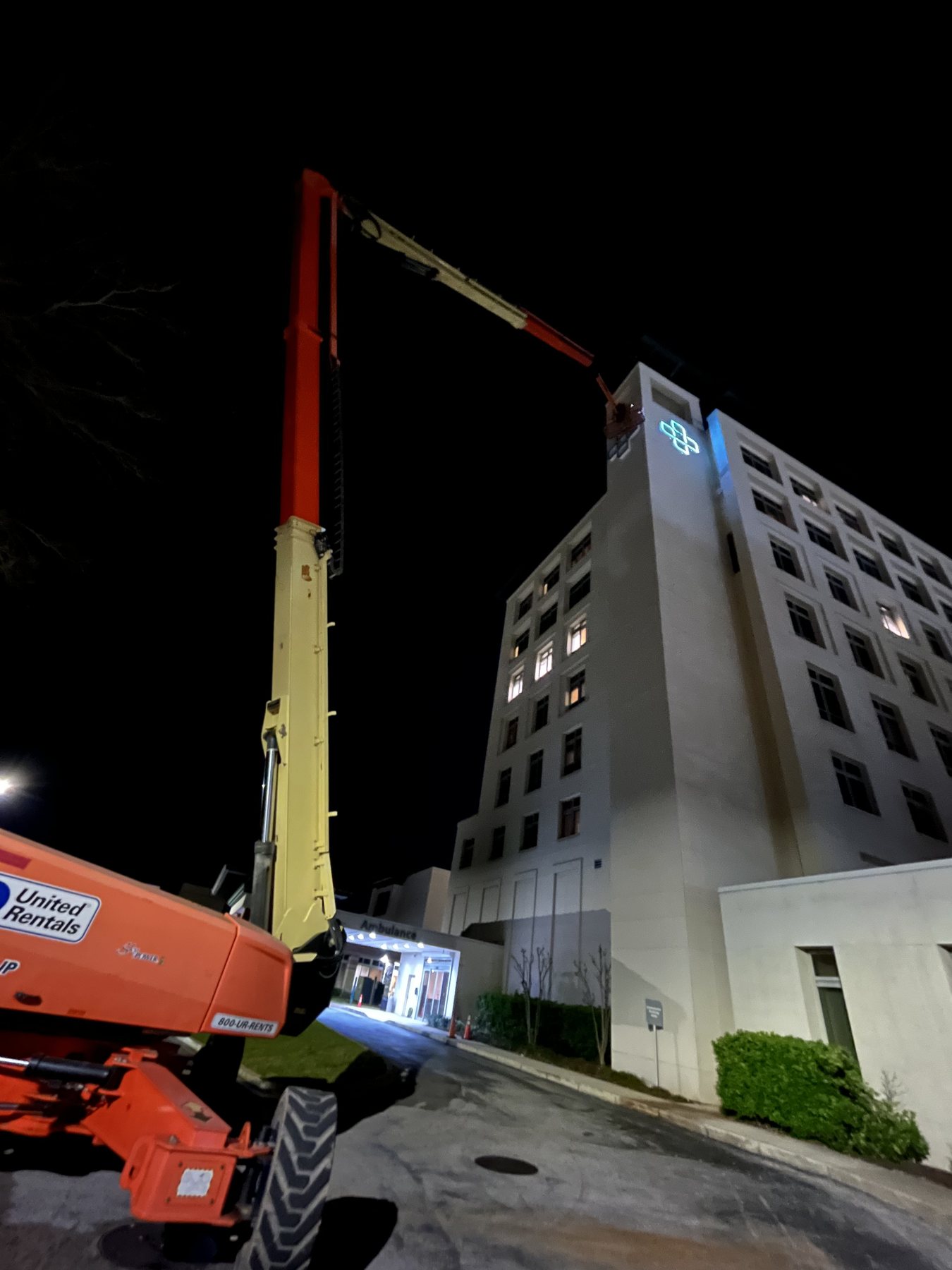 Night crane installation for illuminated high-rise building signage